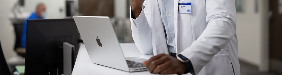 Clinician on MacBook healthcare