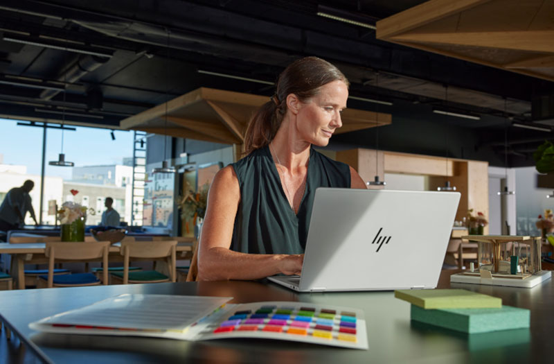Business professionals working with HP devices in meeting