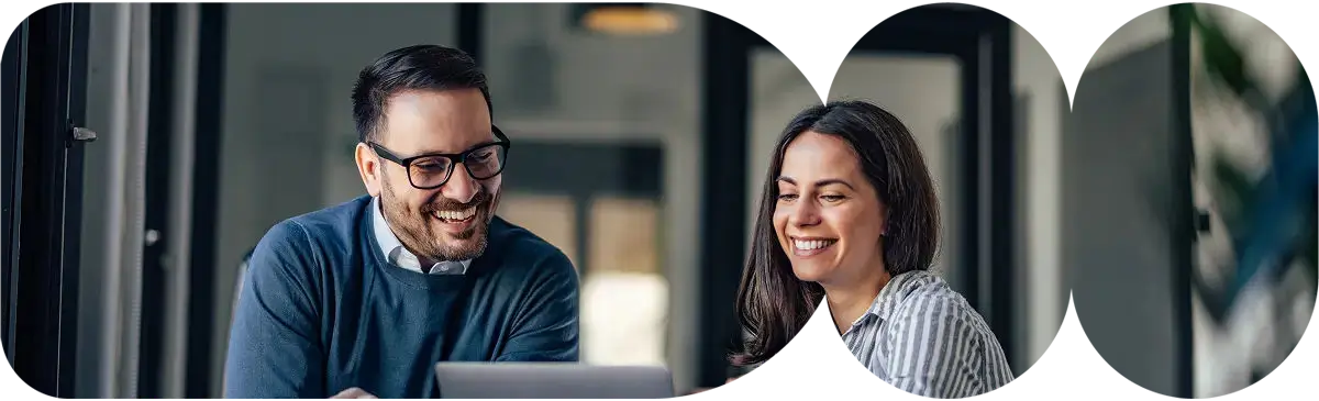 people smiling at a laptop