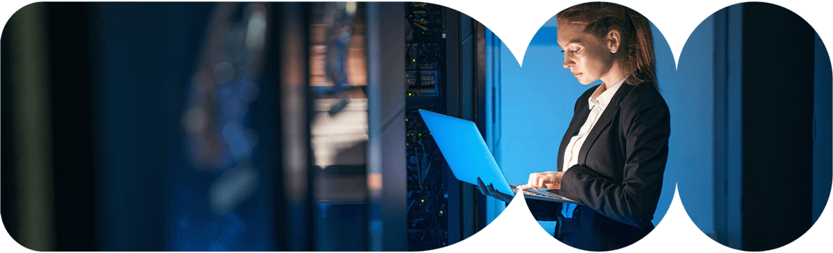 Girl in data center on laptop.
