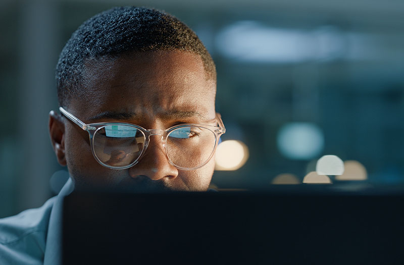 Two-story view of a modern office with workers at dusk.