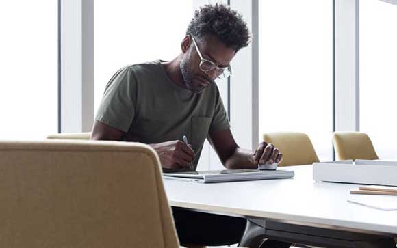 Man working on Microsoft Surface device