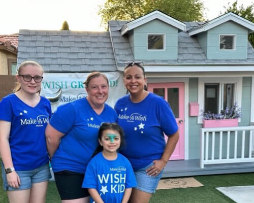 Abbie stands with another Make-A-Wish family.