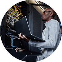 Man inside the data center holding laptop