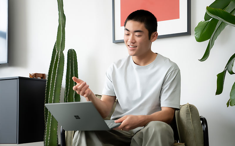 Professional using Windows 11 on Surface device to attend virtual meeting