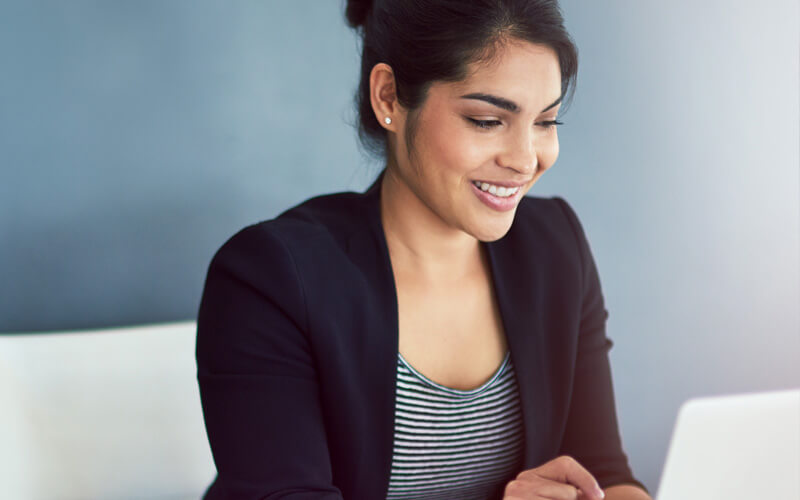 Business woman typing on laptop computer