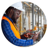 Construction worker with hard hat checking smart phone.