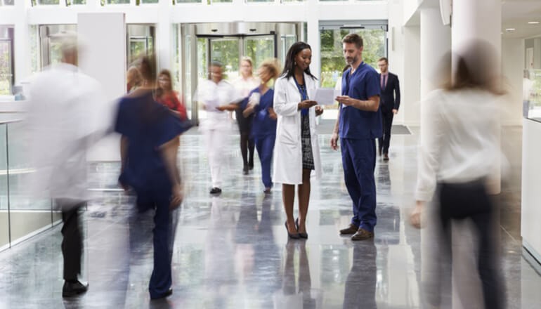 Transform your team’s approach from manual tasks to full automation and seamless growth scaling Doctors talk in hospital lobby