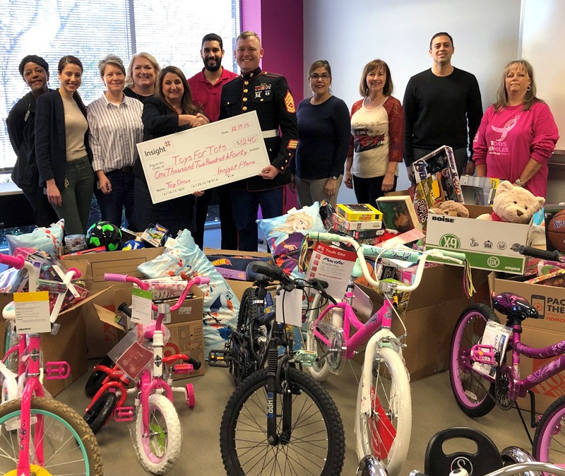 Plano teammates donate money, toys and bicycles to local Toys for Tots.