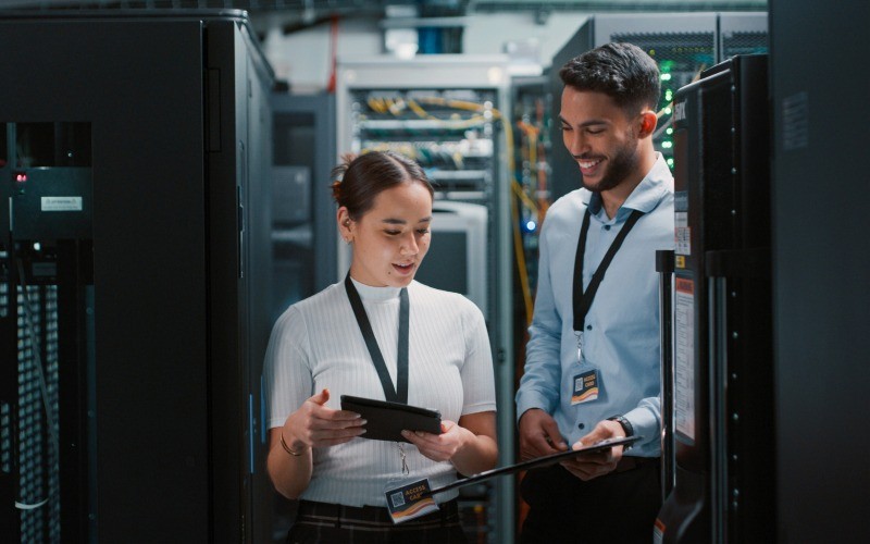 man and woman discussing in a server room