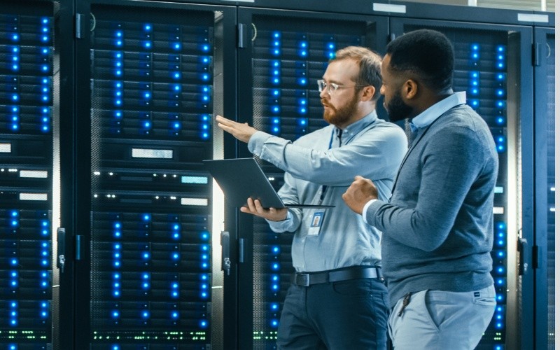 two engineers talking in server room