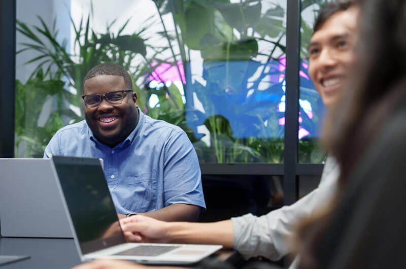 You get experience working at a Fortune 500 company Group of interns collaborating in Insight open office space