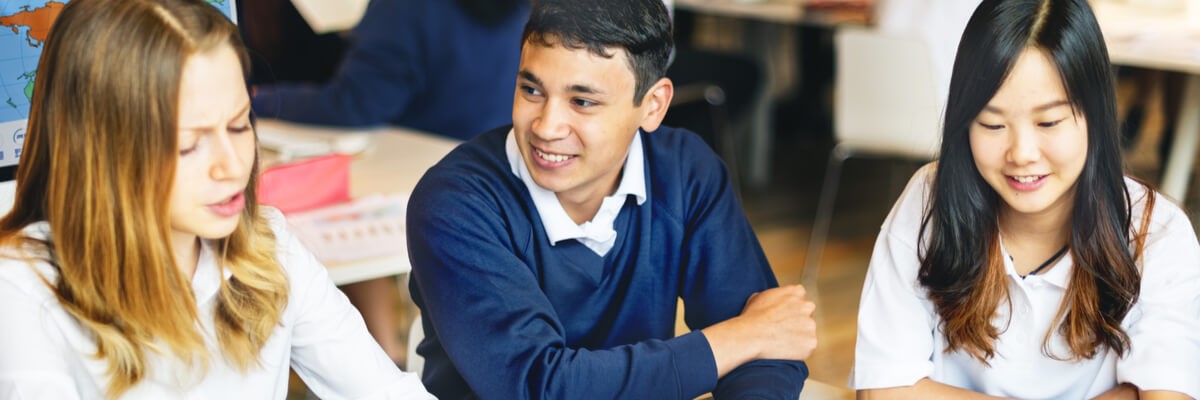 Can One-to-One Initiatives and BYOD in Schools Increase Student Engagement? Young students sitting at desks and looking at tablet devices.