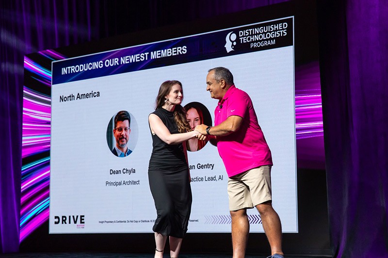Meagan Gentry shakes hand with Juan Orlandini and Phil Hawkshaw at Insight Mastery event 2024