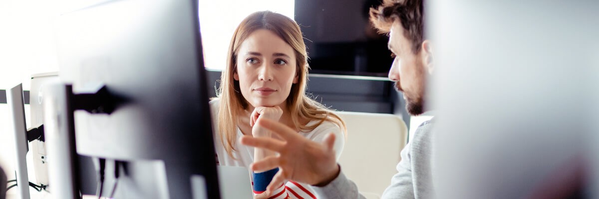 Insight has been recognized as a Red Hat Specialized Partner for automation Business team discussion between computer monitors and information technology