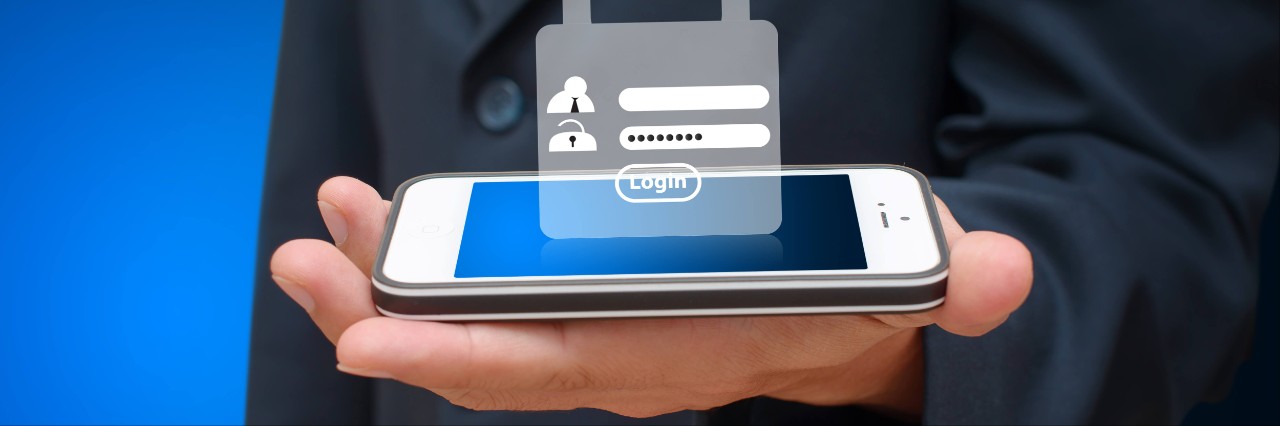 The Balancing Act Between Mobility and Security A person holding a smartphone that has a graphic of a lock resting on top