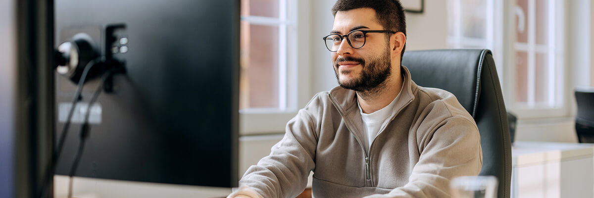 Guy smiling on a desktop