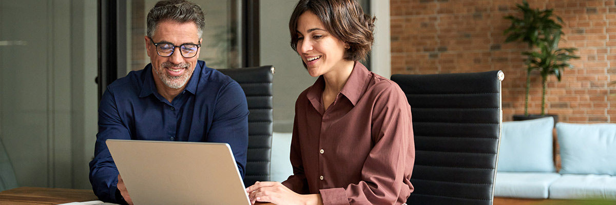 Coworkers working on laptop