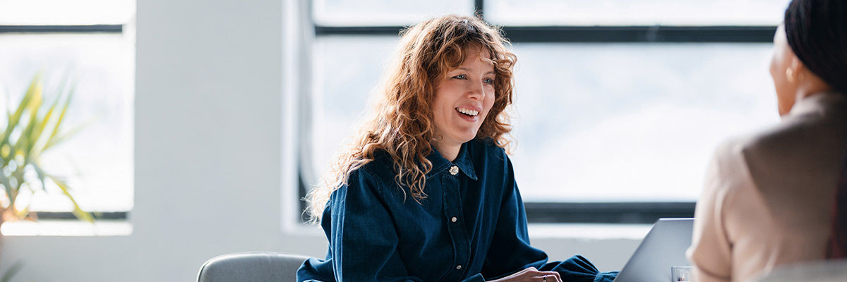 Woman on laptop with colleague