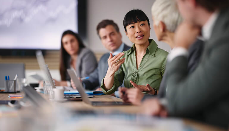 Girl in meeting talking to group