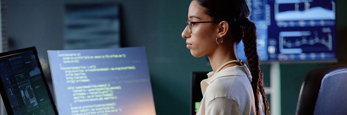 Girl coding on a desktop