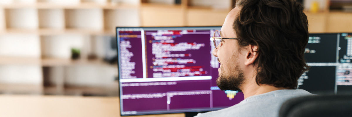 Man smiling at his desktop.