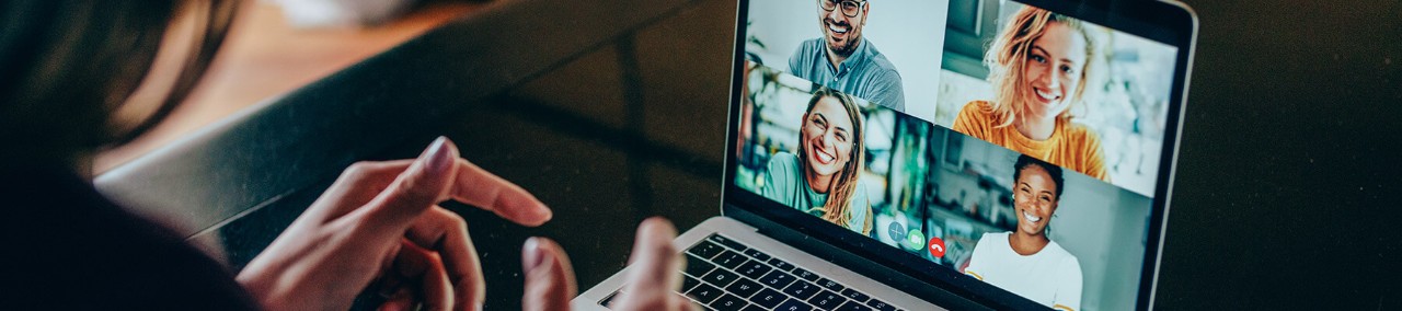 Remote employee collaborating with team over video chat.