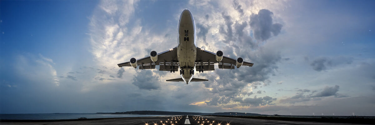 Passenger airplane taking off at sunset.