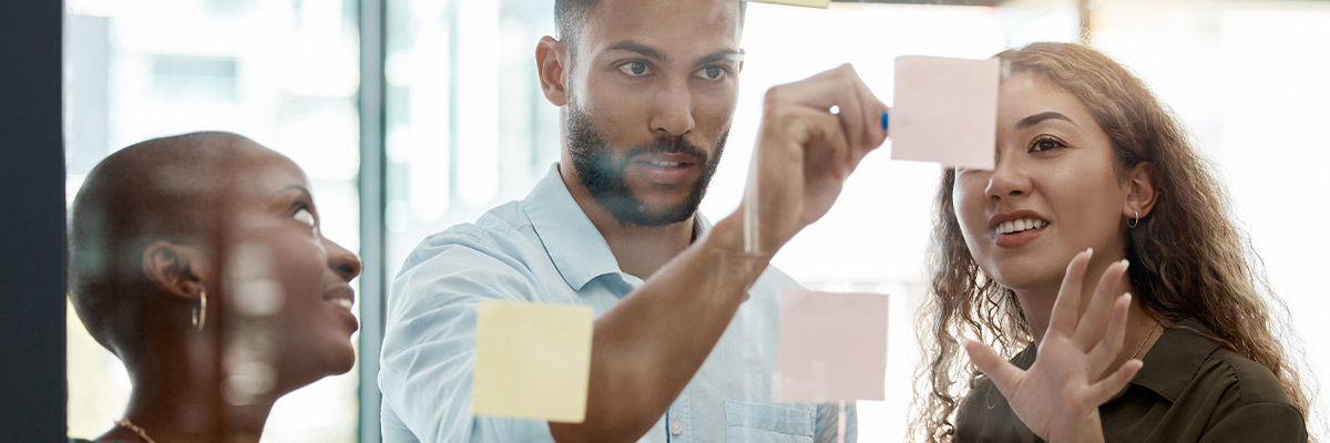 People solving a problem on sticky notes