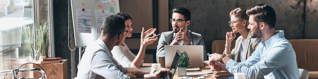 Smiling business colleagues gathered in meeting