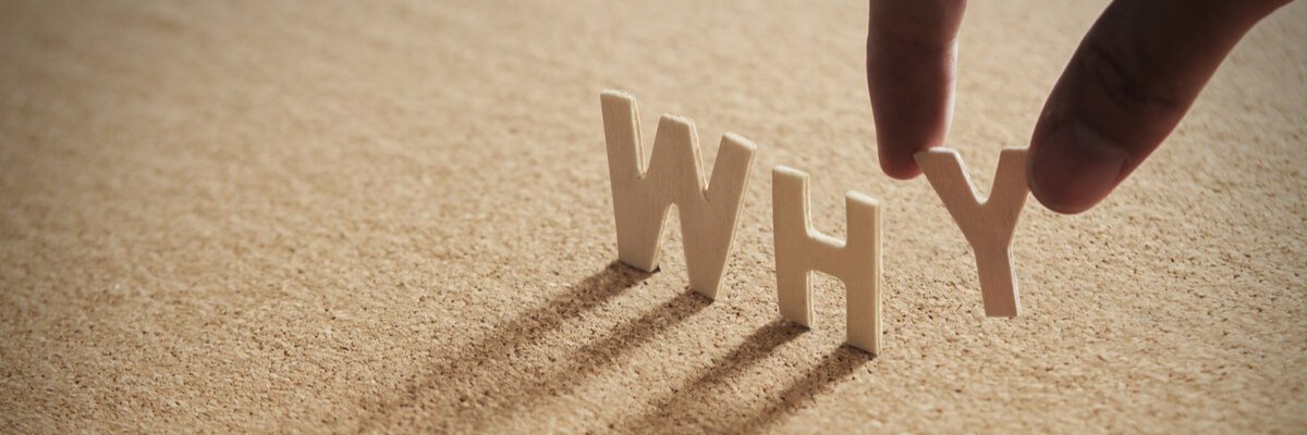 Great product owners always ask why Close up of a hand building out the word why with letters