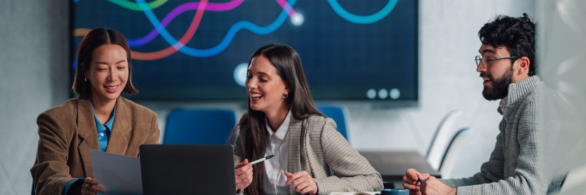 The ROI of Attention: Quantifying the Business Value of Time Saved by AI-Powered Workflows Coworkers smiling and laughing together