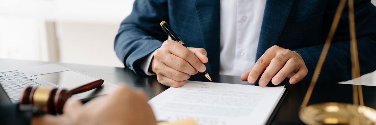 Close up of lawyer signing a contract