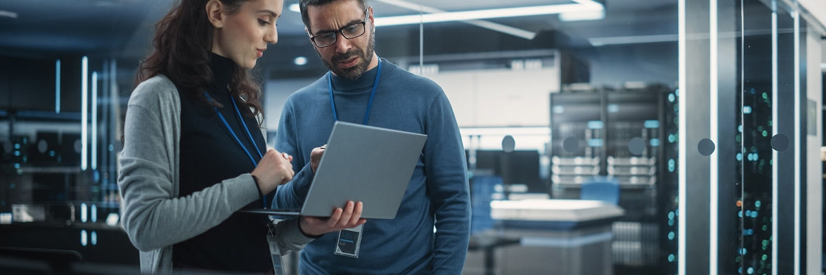 Security room experts looking at a laptop