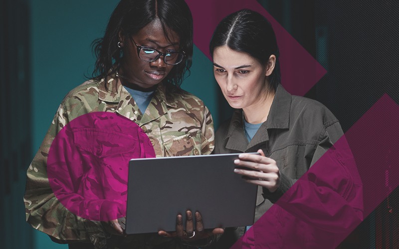 Two military engineers in facility looking at security insights
