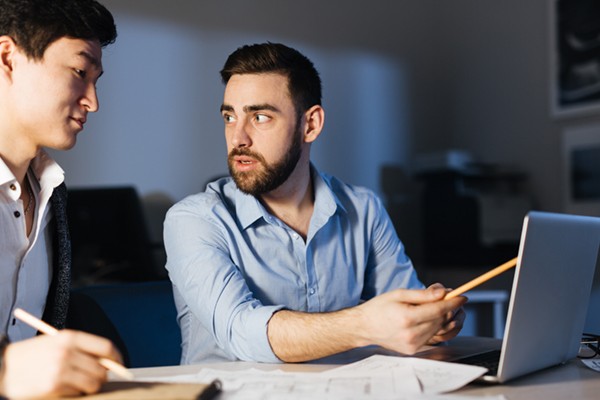 IT professional explaining process to colleague