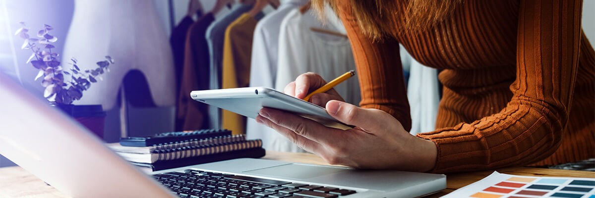 Retail merchandiser reviewing design concepts off Apple devices as they are working on store displays and visual concepts. 