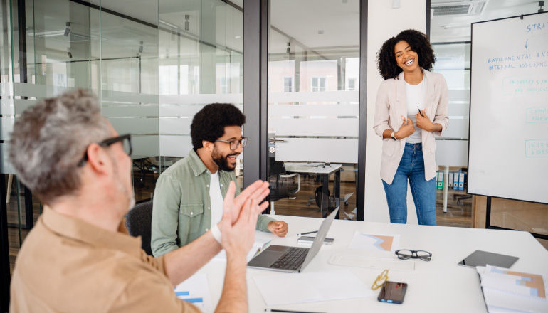 BlackLine Hits 99% Adoption of Gemini Enterprise With Insight Someone in office presenting at whiteboard.