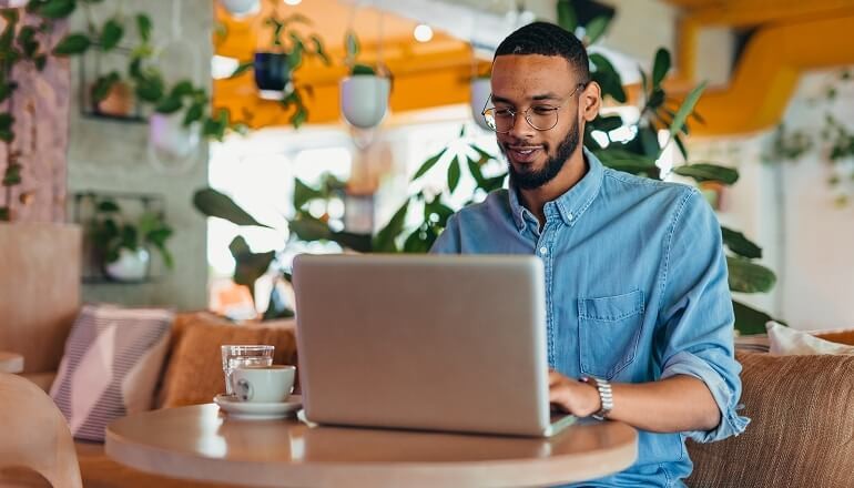 guy smiling on laptop