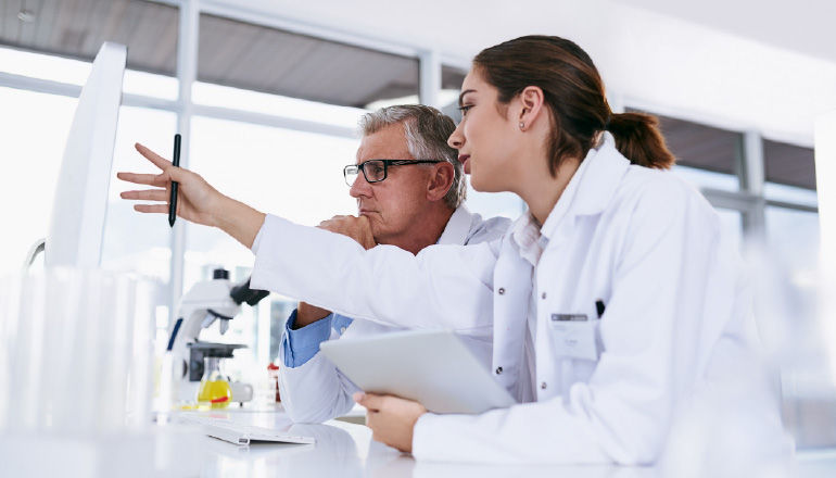 Healthcare professional in office on a tablet.