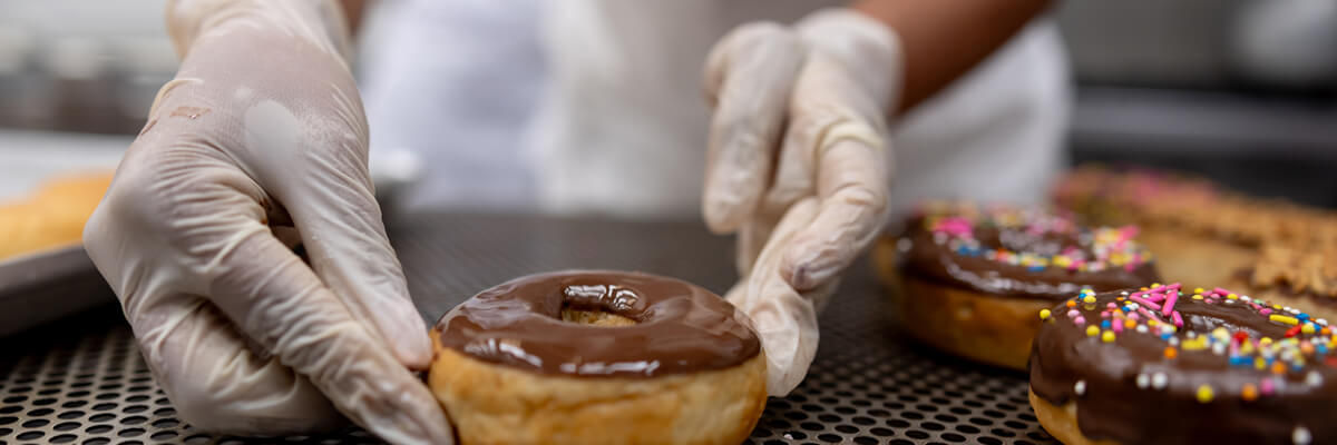 Chef in kitchen working on donuts