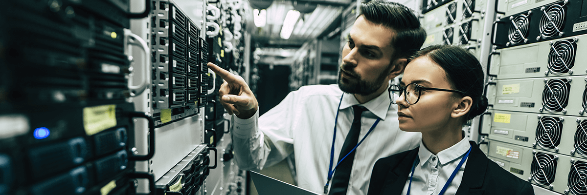 Evaluate the technology landscape and enhance your overall effectiveness. Two business people looking at a server