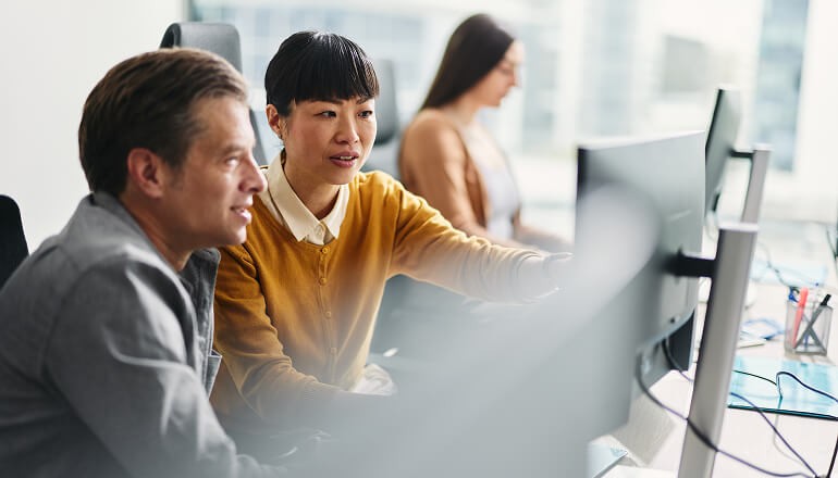 Business people looking at monitor
