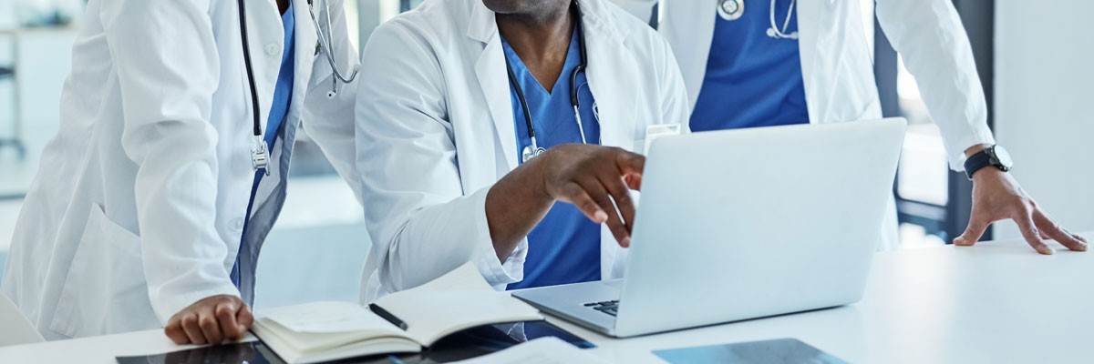 Machine Learning Brings New Hope for Better Patient Outcomes Doctors around laptop