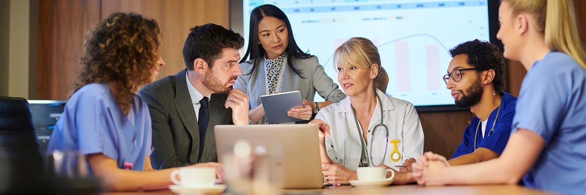 Hospital staff has conversation. Cisco Security Enterprise Agreement, Cisco Security EA