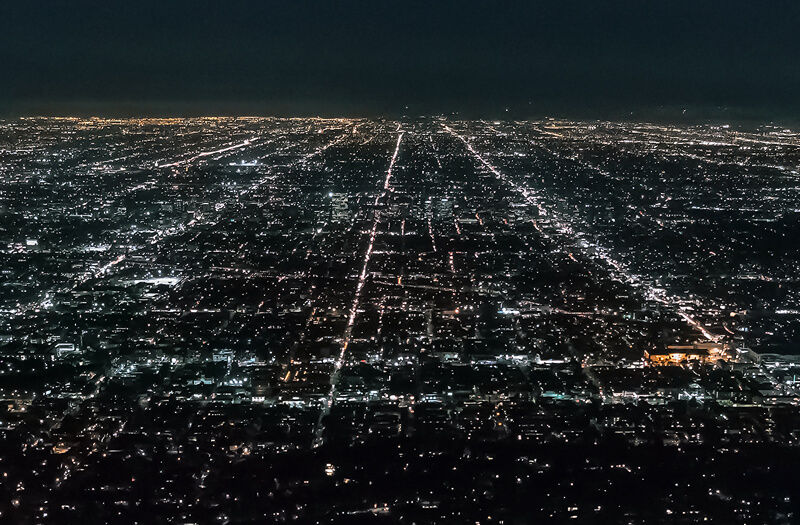 City skyline at night, aerial metropolis twilight, urban resilience, smart city lights, sprawling city aerial.