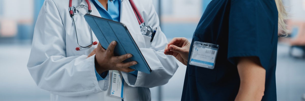 Doctor and nurse review patient data on tablet device
