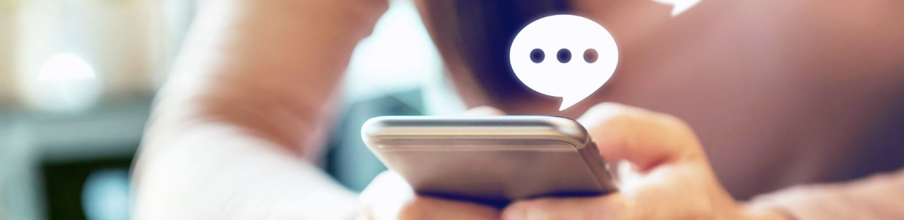 Fingers typing message on smart phone