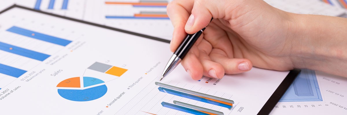 Close up of pen on papers with charts