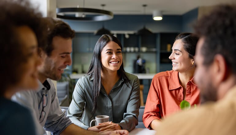 Questrade Financial Group (QFG): Maintaining a people-focused company culture of care People working together in a meeting